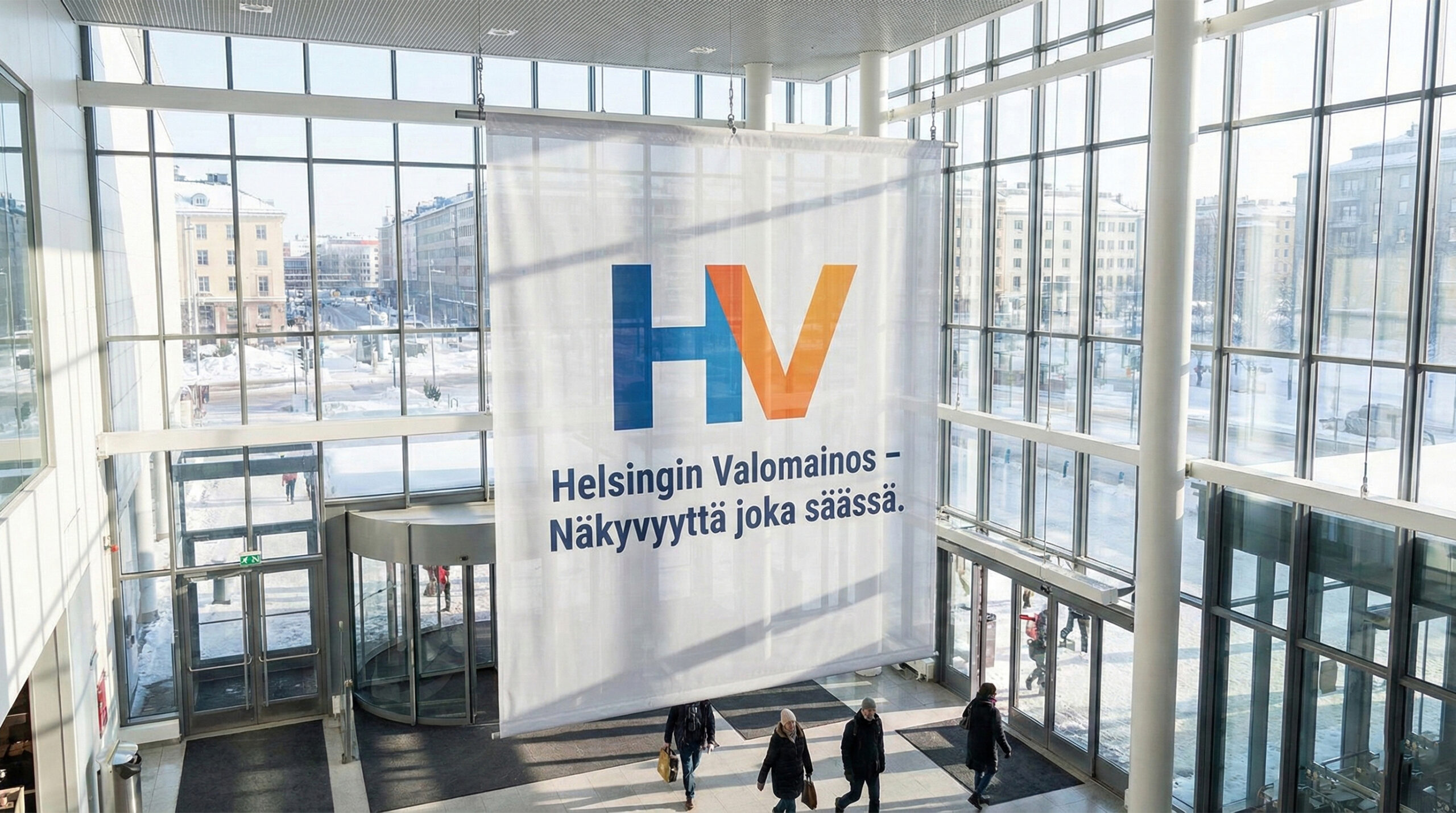 Helsingin Valomainoksen banderolli kauppakeskuksen lasijulkisivussa